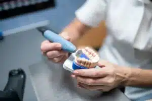 Dental prosthesis in hands of dental technician